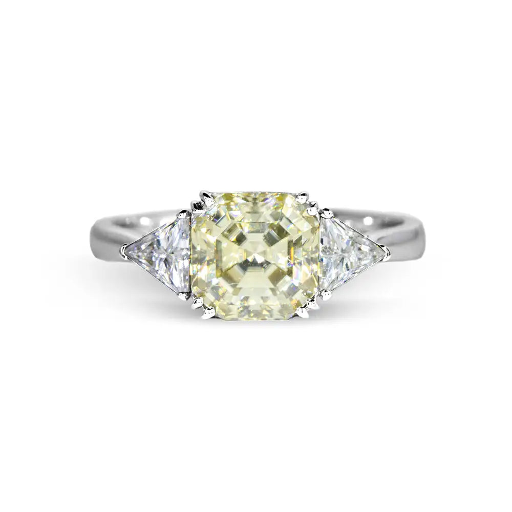 Stefani Asscher in Canary Yellow Moissanite with Trilliant Side Stones Trilogy Ring in 18K gold - LeCaine Gems